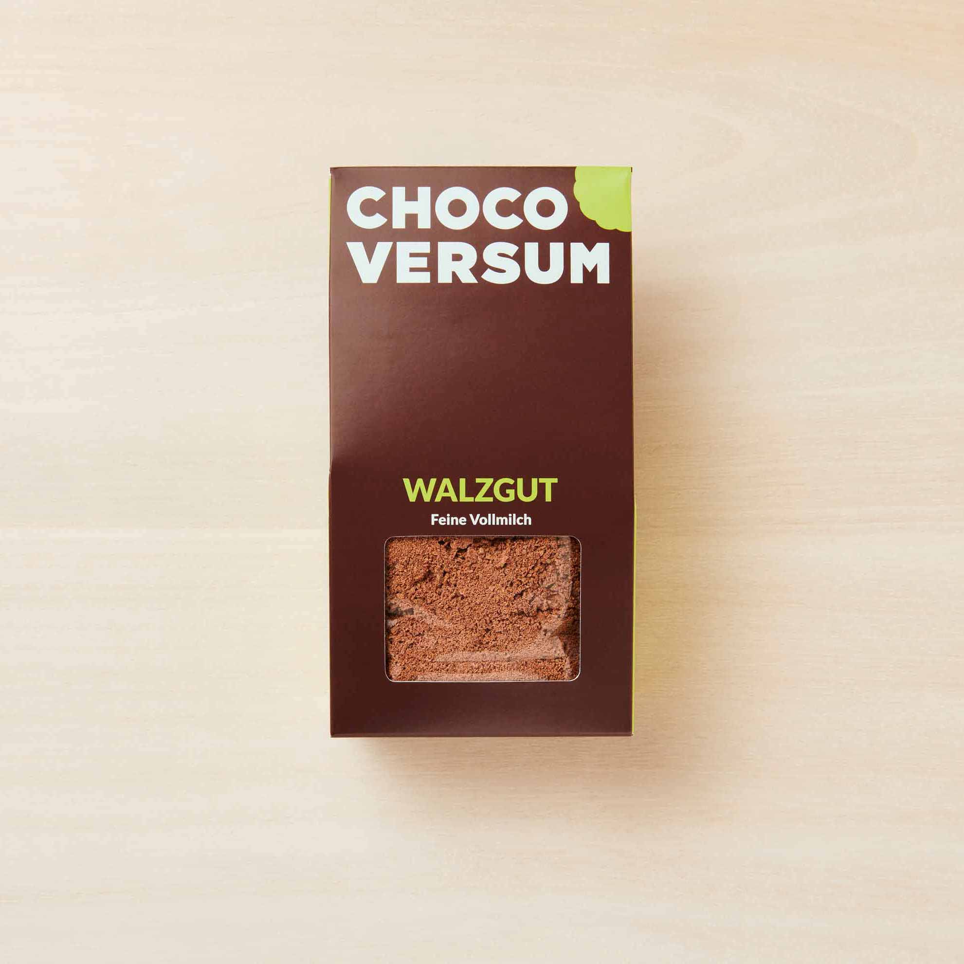 Chocoversum Walzgut Vollmilchschokolade in Sichtverpackung – feine geriebene Schokoladenflocken in braunem Karton.