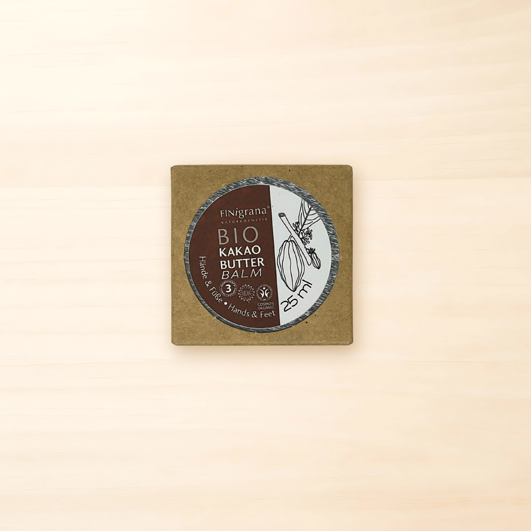 FINigrana BIO-Kakaobutter Balm im 25-ml-Tiegel in einer naturbraunen Kartonverpackung mit Sichtfenster und Kakaoschoten-Illustration.